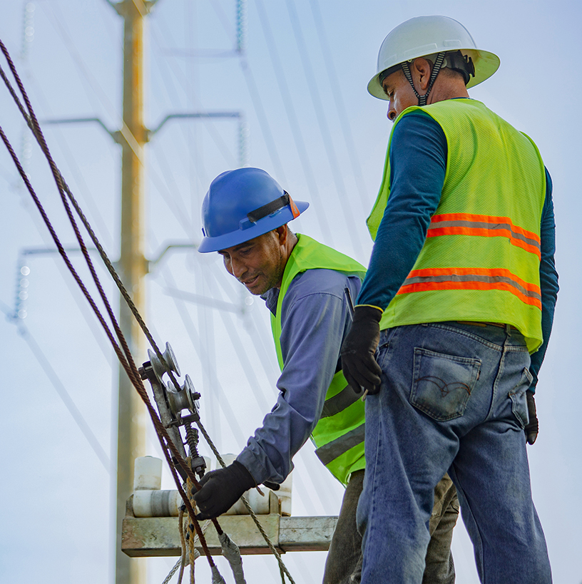 Field workers on transmission tower